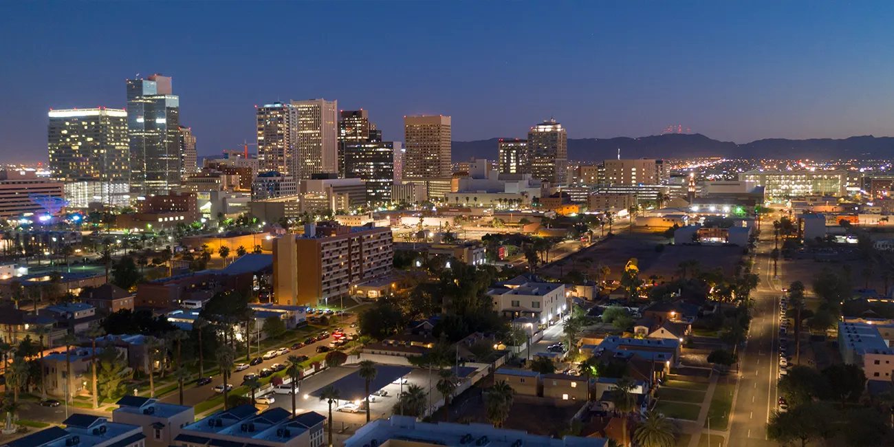 A nighttime view from the air of Phoenix, AZ skyscrapers