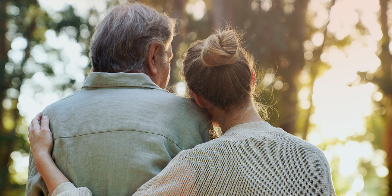 Father and daughter leaning on each other for support