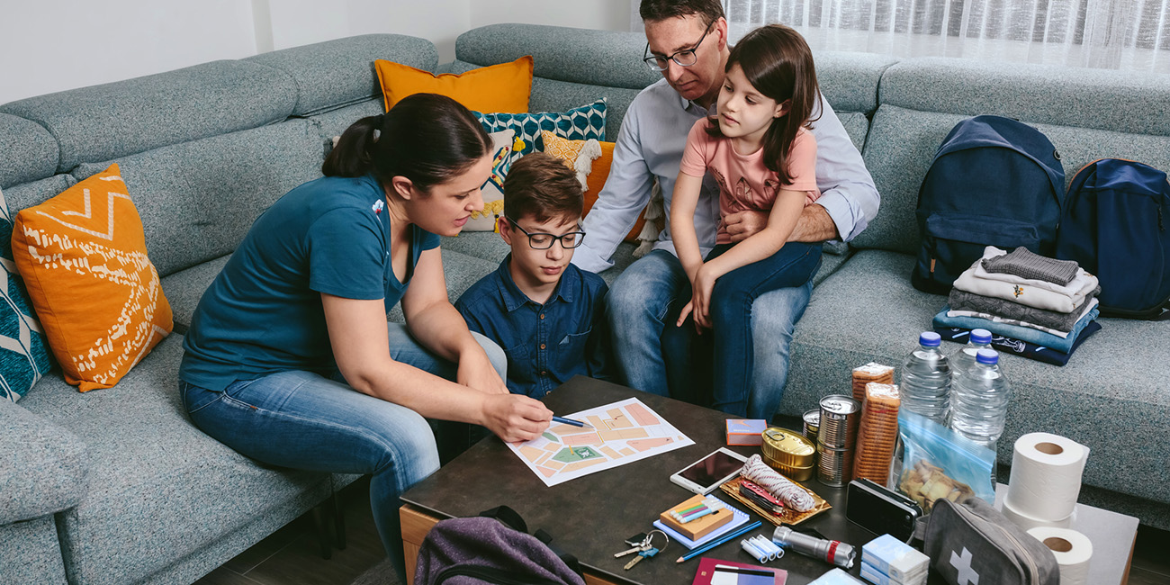 AOH-blog-Resources-TornadoPrepareness Family going over a plan and emergency supplies for a natural disaster