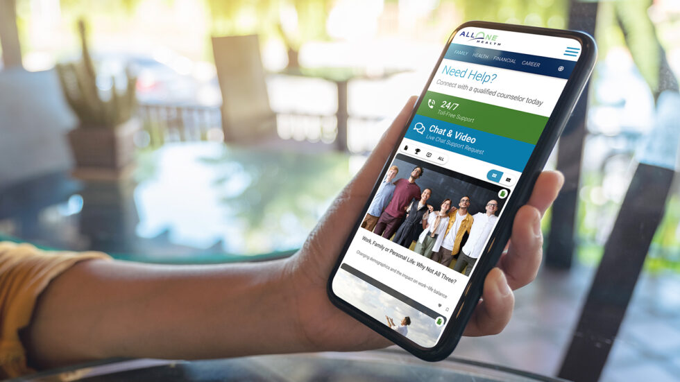 Someone holding a phone and using the AllOne Health app