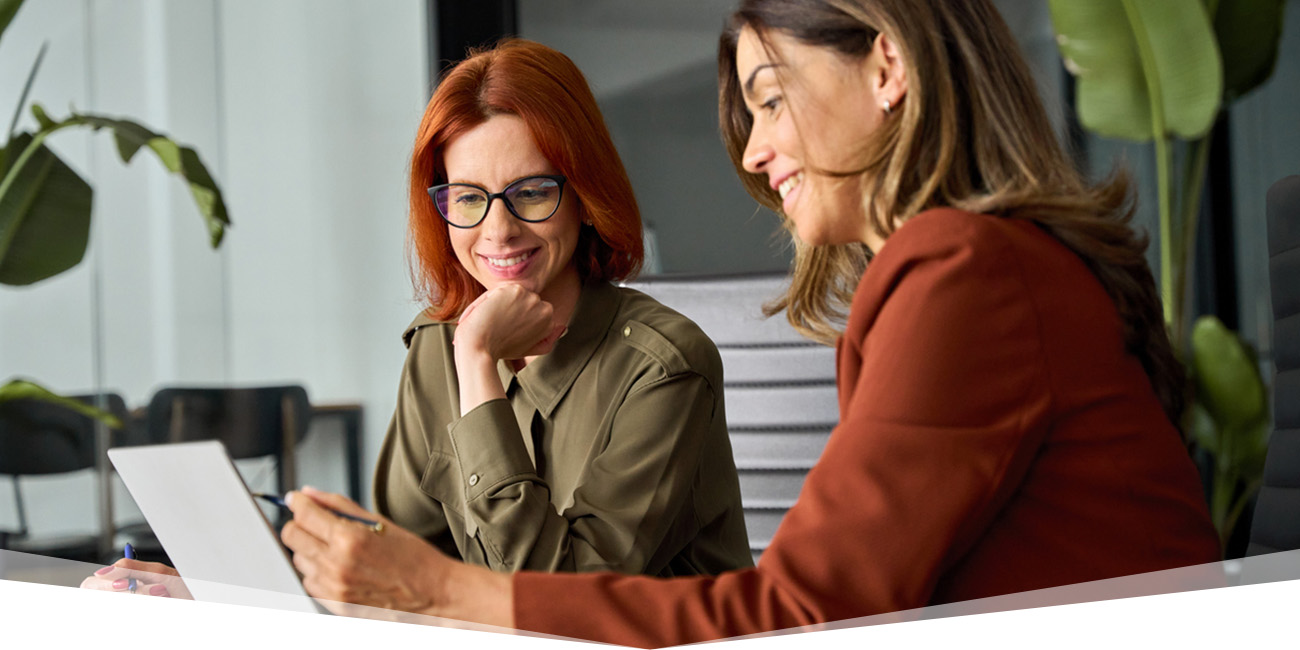 Two employees working together at a conference table