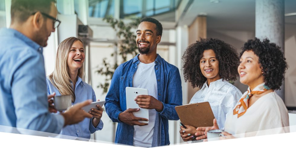 Employees standing in a circle chatting