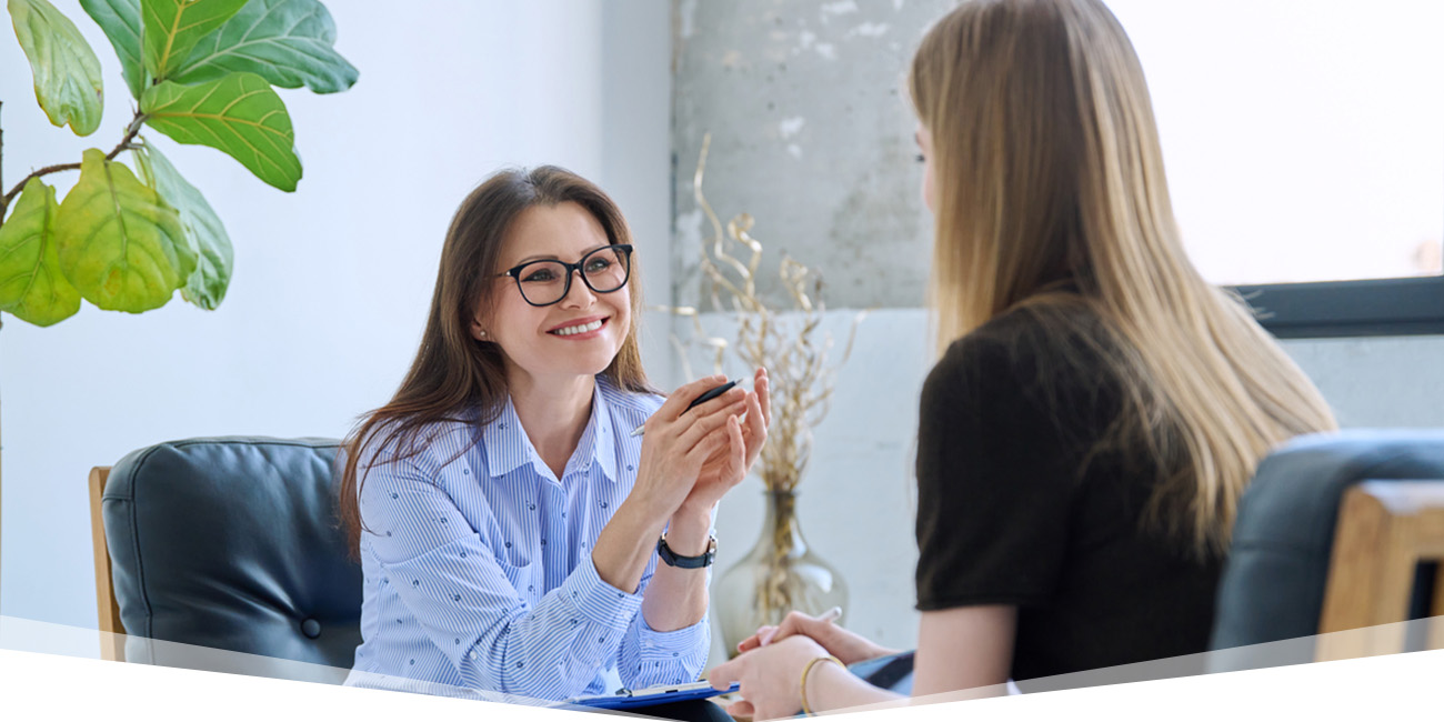 A healthcare worker listening to an employee